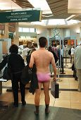 picture of security  - Man standing in his underwear waiting to go through an airport security check station - JPG 