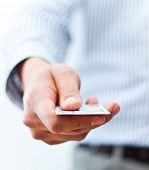 foto of currency  - Male hand showing credit card - JPG 