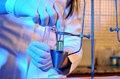foto of medical  - A medical assistant working on traditional measure equipment at pathology lab - JPG 