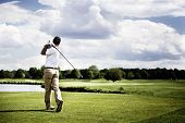 pic of golf  - Male golf player teeing off golf ball from tee box - JPG 