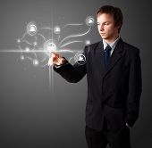 stock photo of business people  - Businessman pressing modern social buttons on a virtual background - JPG 