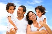 pic of family  - happy family smiling outdoors while on vacation - JPG 