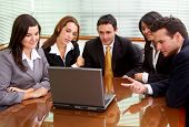 image of meeting  - businessmen and businesswomen in a business meeting in an office smiling - JPG 