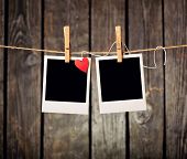 image of  photo  - Blank instant photos and small red paper heart hanging on the clothesline - JPG 