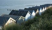 stock photo of hut  - Rear view of a row of beach huts at Clacton - JPG 