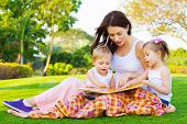 stock photo of  photo  - Photo of young brunette woman teaching two sweet kids - JPG 