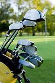 stock photo of golf  - A set of golf clubs on a golf course on a beautiful sunny day - JPG 
