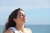pic of holidays  - Beautiful girl breathing on the beach with the sea in the background - JPG 