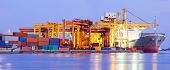 foto of industrial  - Panorama of Industrial Container Cargo freight ship with working crane bridge in shipyard at dusk for Logistic Import Export background - JPG 