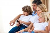 image of family  - Young Family watching TV in the living - JPG 
