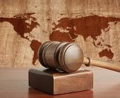 stock photo of world  - Wooden gavel on a background map of the world - JPG 