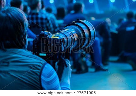 Poster: Journalist photographer with a telephoto