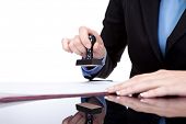image of pressure  - female hands stamping document in office - JPG 