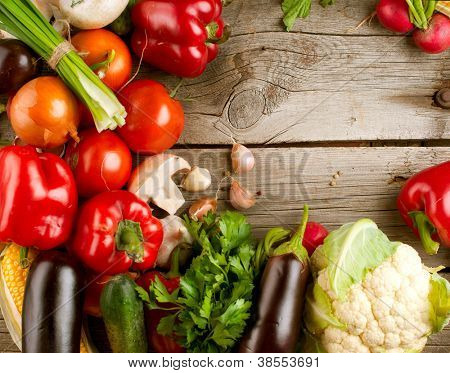 Picture or Photo of Healthy Organic Vegetables on a Wooden Background. Art Border Design