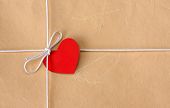 picture of cord  - A bow from a string with valentine card on a brown packing paper - JPG 