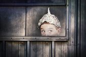 foto of boy  - Boy in a tin foil hat peeking out of a window - JPG 