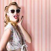 picture of cultures  - Surprised Young Woman With Pinup Hair Style And Makeup Posing In Striped Copy Space Retro Studio - JPG 
