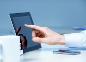picture of internet  - Hand pointing on modern digital tablet pc at the workplace - JPG 