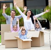 picture of family  - Family with arms up celebrating they are moving home - JPG 