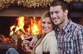 picture of home  - happy Young romantic couple and relaxing sofa in front of fireplace at winter season in home - JPG 