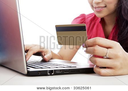 Picture or Photo of Shot of smiling woman with laptop and a credit card isolated on white