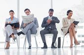 stock photo of wait  - Waiting room with business people sat in line - JPG 