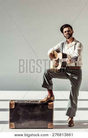 Poster: Bearded Man In Cap Near