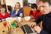 pic of france  - Teenage Family Using Gadgets Whilst Eating Breakfast Together In Kitchen - JPG 