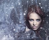 foto of attractive  - Fashion shoot of young attractive woman in blowing silk over the snowy background - JPG 