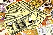 stock photo of currency  - Pair of dice rolling a sure bet on American money over foreign currency - JPG 