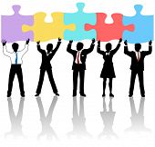 image of objects  - Team of business people collaborate holding up jigsaw puzzle pieces as a solution to a problem - JPG 