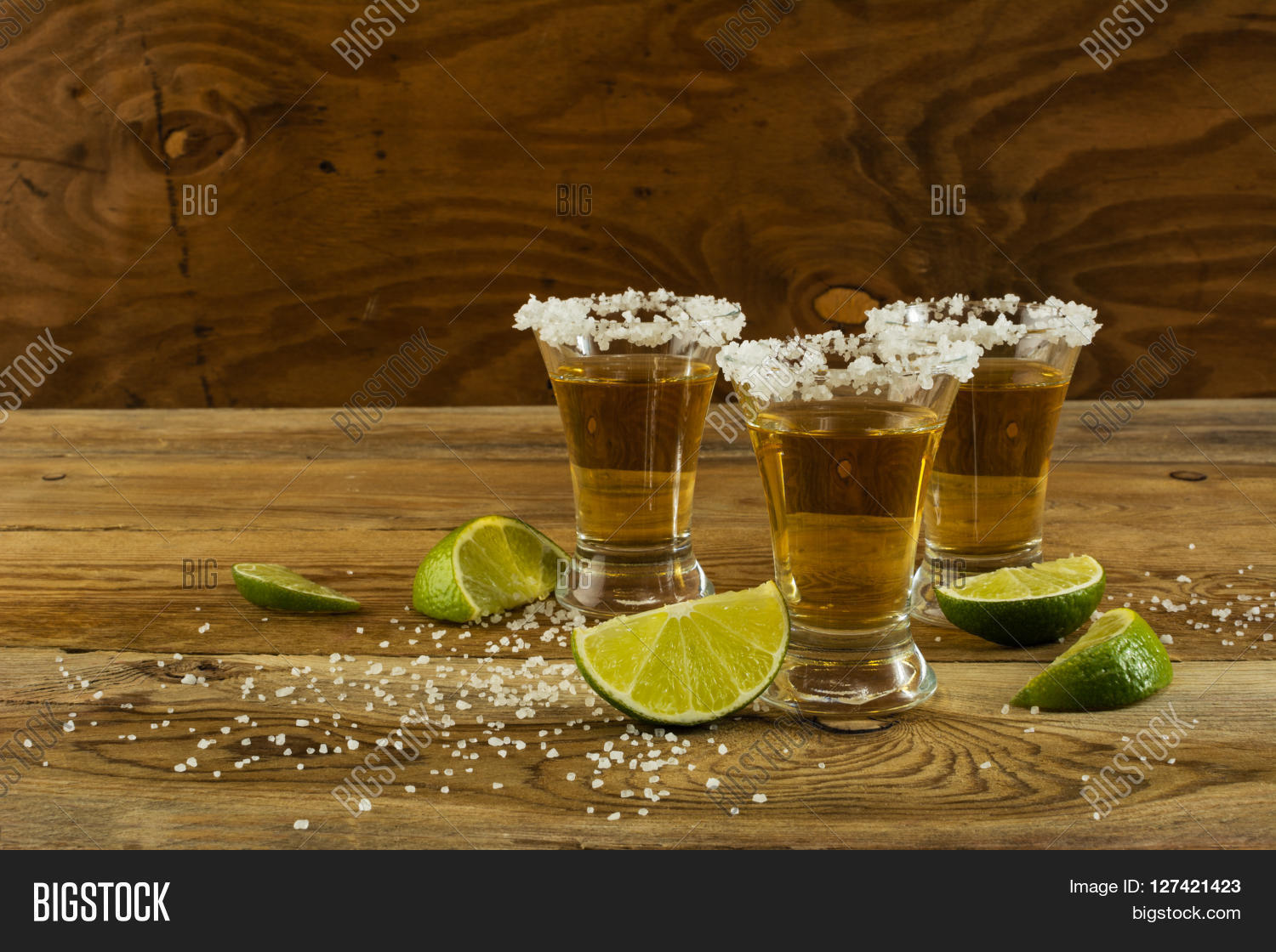 Two gold tequila shots copy space. Tequila shot. Gold Mexican tequila