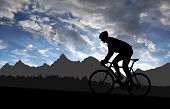 stock photo of sunset  - silhouette of the cyclist riding a road bike at sunset - JPG 
