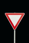 image of yield  - the red and white yield sign in front of black background - JPG 