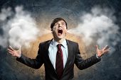 picture of pressure  - businessman in anger screaming puff going out from ears - JPG 