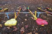 foto of teeter  - Teeter totter in a park during fall - JPG 