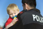 pic of security  - Police Officer securely holds and protects infant - JPG 