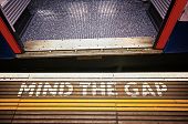 pic of gap  - Warning sign at Tube station and motion blured train in London - JPG 