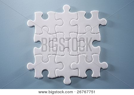 Picture or Photo of Puzzle pieces isolated on the blue background