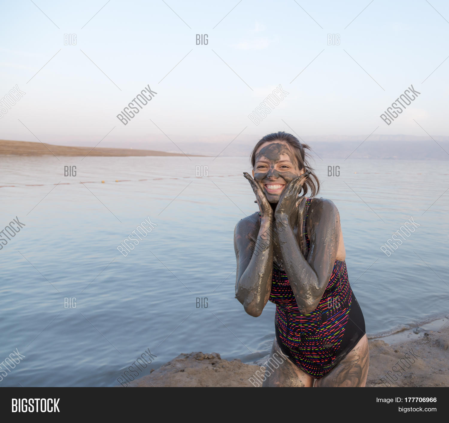 Portrait Of Beautiful Girl Applying Dead Sea Mud Body Care Treatment In