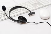 picture of headphones  - Office black headphones laying on white keyboard isolated - JPG 
