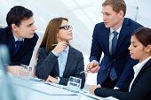 picture of meeting  - Group of business partners listening to young manager at meeting - JPG 