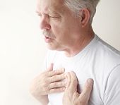 stock photo of pressure  - senior has trouble breathing with chest pain - JPG 