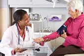 picture of pressure  - Doctor Taking Senior Female Patient - JPG 