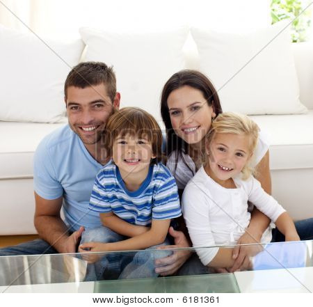 Picture or Photo of Portrait of happy family smiling at the camera in living-room
