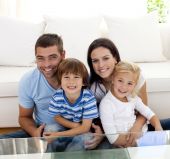 stock photo of family  - Portrait of happy family smiling at the camera in living - JPG 