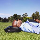 pic of businessmen  - African businessman laying in grass - JPG 