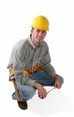 pic of construction worker  - A male construction work kneeling with his tools - JPG 