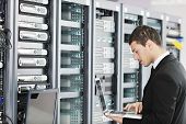 stock photo of security  - young it  engeneer business man with thin modern aluminium laptop in network server room - JPG 