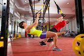 picture of fitness  - Crossfit fitness TRX training exercises at gym woman and man push - JPG 